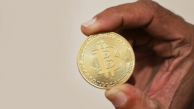 Physical crypto coin held in a hand